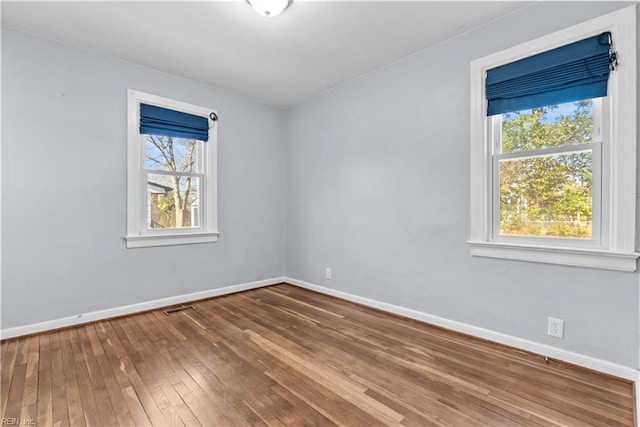 spare room featuring hardwood / wood-style floors