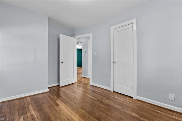 unfurnished bedroom with hardwood / wood-style floors