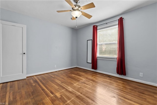 spare room featuring hardwood / wood-style flooring and ceiling fan