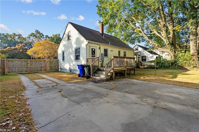 back of house featuring a wooden deck