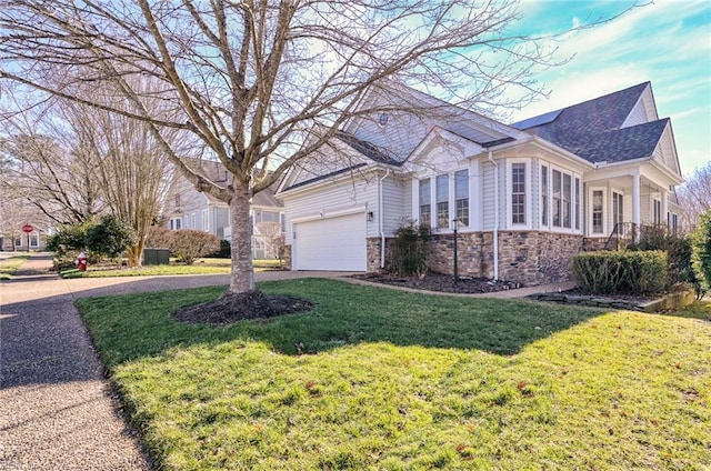 view of side of property with a yard and a garage