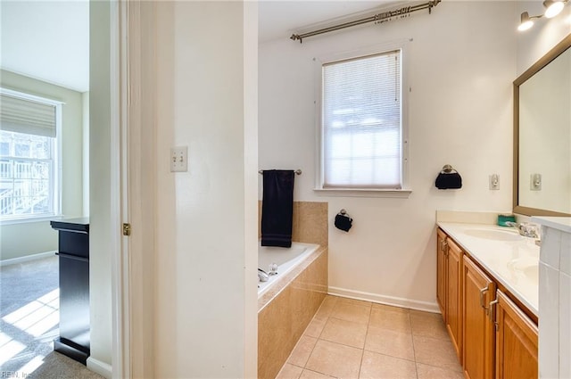 bathroom with vanity, tile patterned floors, and tiled bath