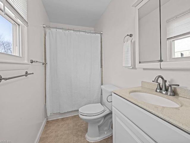 bathroom with tile patterned floors, toilet, vanity, and walk in shower