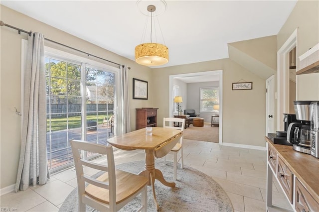 dining area featuring light tile patterned flooring and baseboards