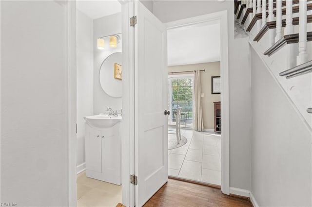 interior space with stairway, wood finished floors, and baseboards