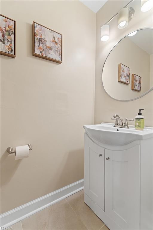 bathroom featuring vanity, baseboards, and tile patterned floors