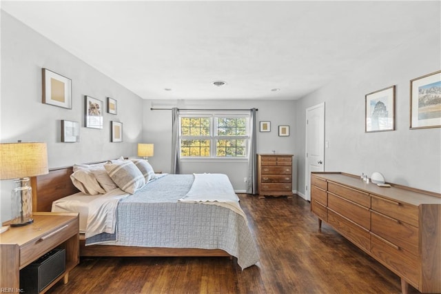 bedroom featuring dark wood-style floors, visible vents, and baseboards