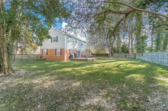 view of yard with a fenced backyard and a wooden deck