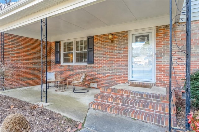 entrance to property with brick siding