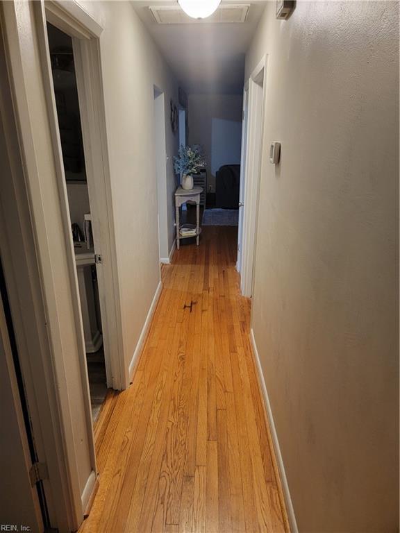 hall with light hardwood / wood-style floors