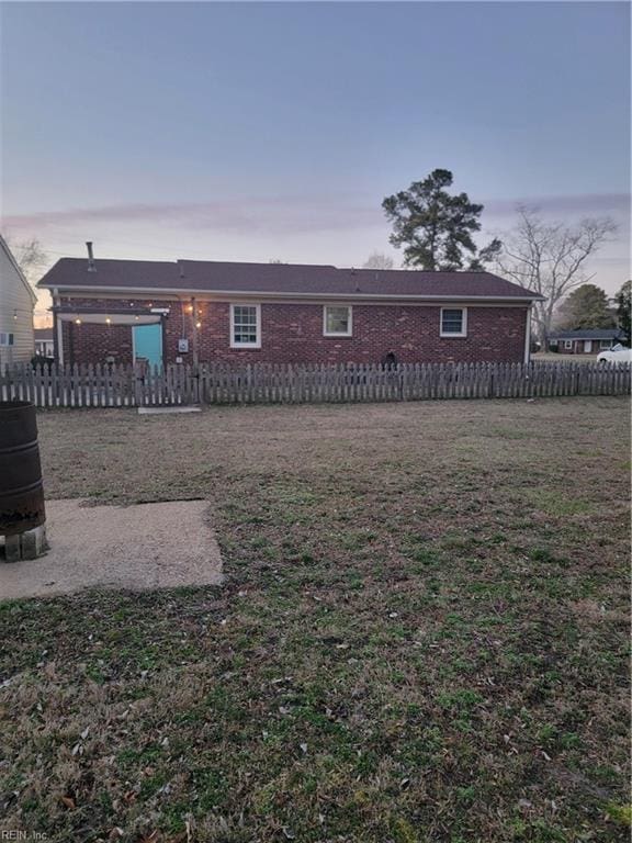 view of back house at dusk