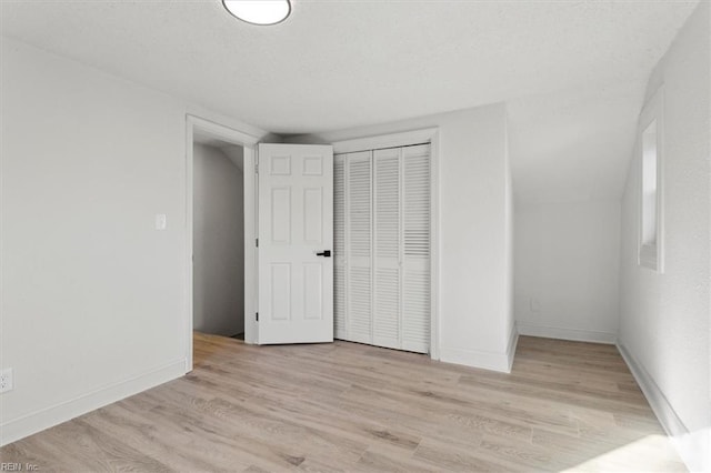 unfurnished bedroom featuring light hardwood / wood-style floors and a closet