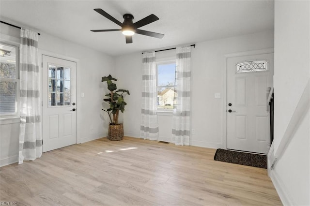 entryway featuring ceiling fan, light hardwood / wood-style floors, and a healthy amount of sunlight