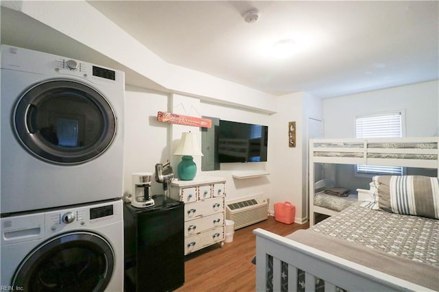 washroom with stacked washer and dryer and dark hardwood / wood-style flooring