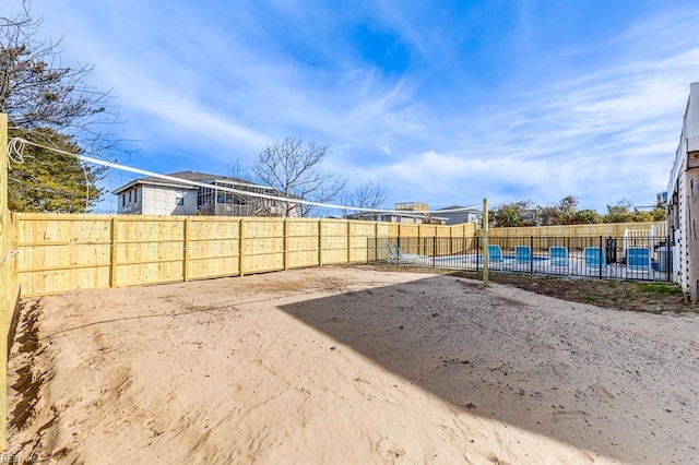 view of yard with a swimming pool and volleyball court