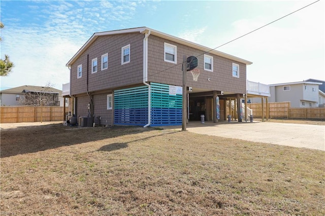 back of house with a yard and a carport