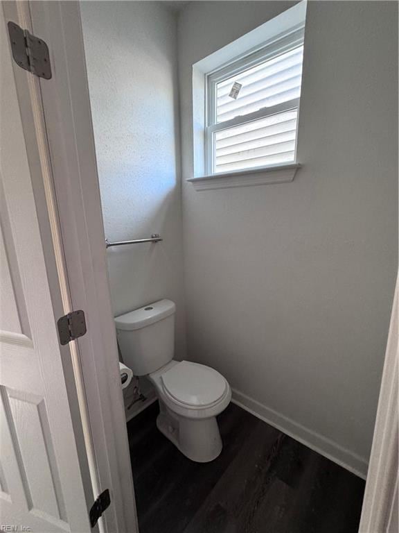 bathroom featuring hardwood / wood-style flooring and toilet