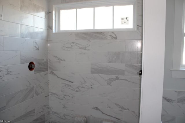 bathroom with a tile shower