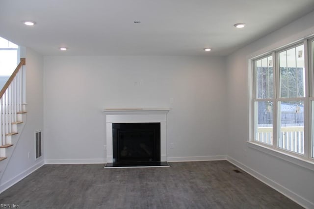 unfurnished living room with dark hardwood / wood-style floors