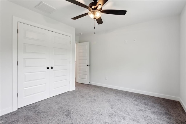 unfurnished bedroom featuring visible vents, carpet, baseboards, and a closet