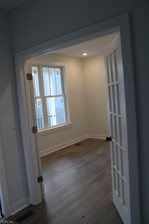 spare room with dark wood-type flooring