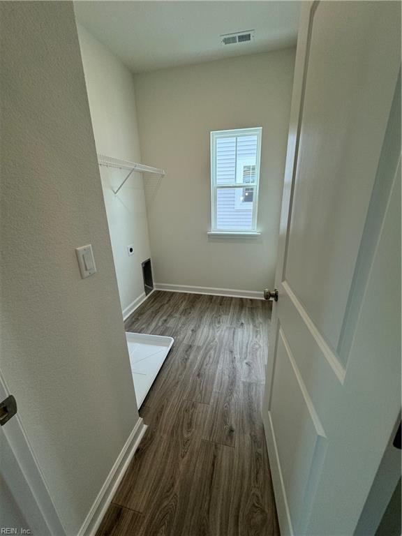 laundry area with dark wood-type flooring and hookup for an electric dryer