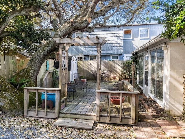 deck featuring fence and a pergola