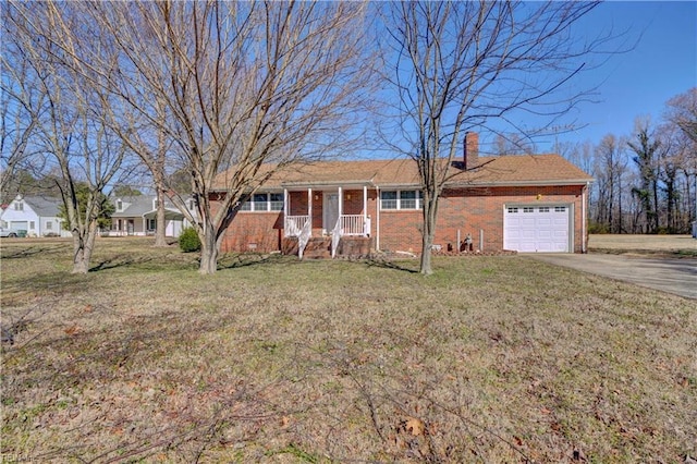 single story home featuring covered porch, a front yard, and a garage