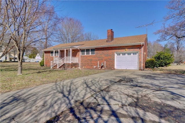 ranch-style home with a garage, covered porch, and a front lawn