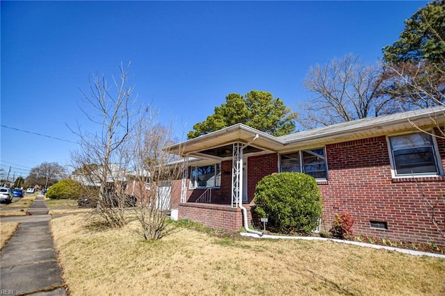 bungalow-style house with a front lawn