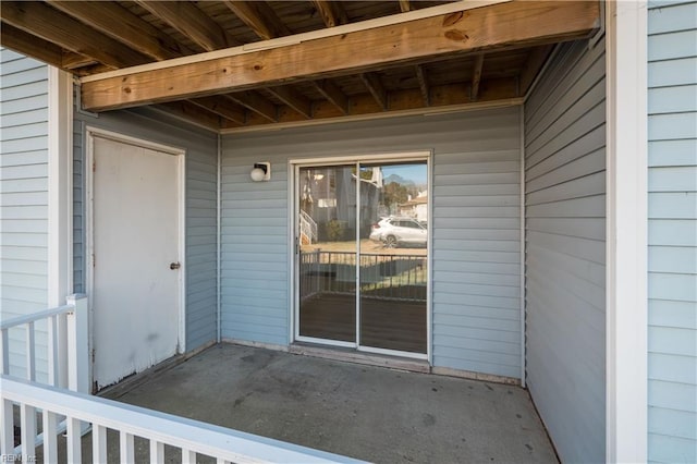 view of exterior entry featuring a patio area