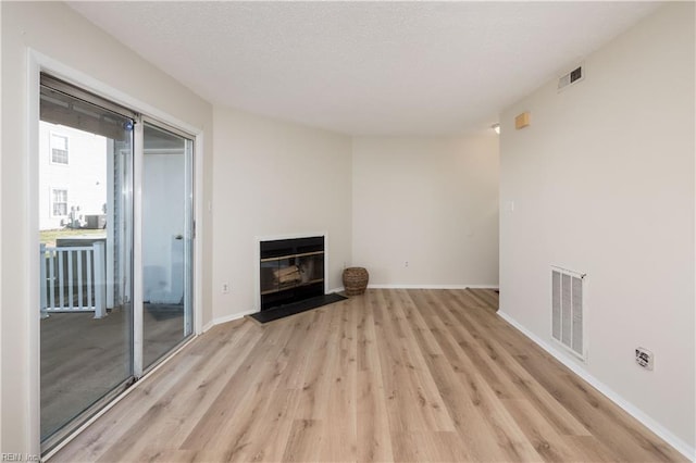 unfurnished living room with light wood-type flooring