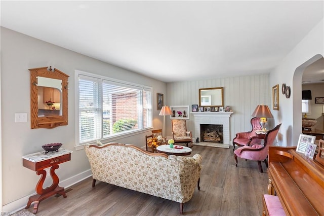 living room featuring dark hardwood / wood-style floors and a brick fireplace