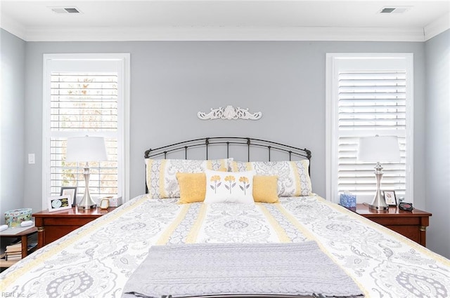 bedroom featuring ornamental molding and visible vents