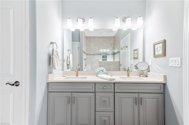 bathroom with a walk in shower, double vanity, and a sink