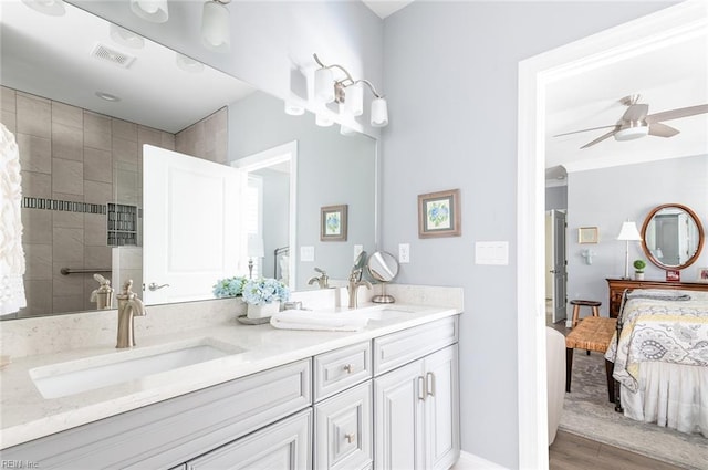 ensuite bathroom with double vanity, visible vents, ceiling fan, ensuite bathroom, and a sink