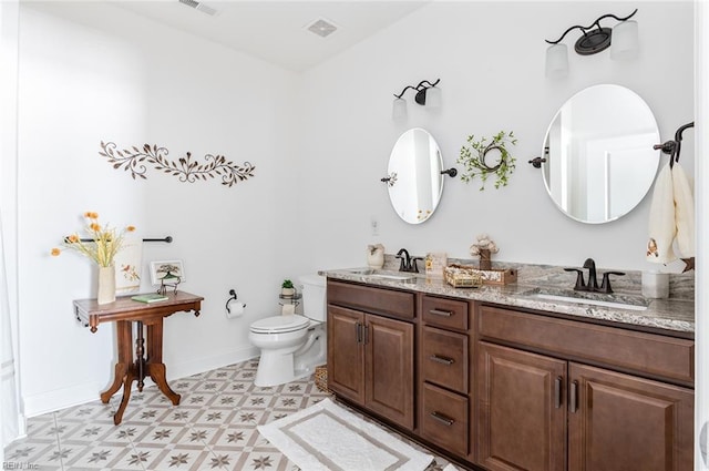 bathroom featuring baseboards, visible vents, a sink, and toilet