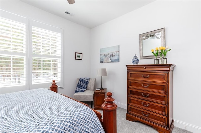 bedroom featuring light carpet, ceiling fan, visible vents, and baseboards