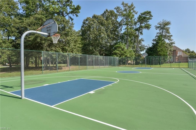 view of basketball court with community basketball court and fence