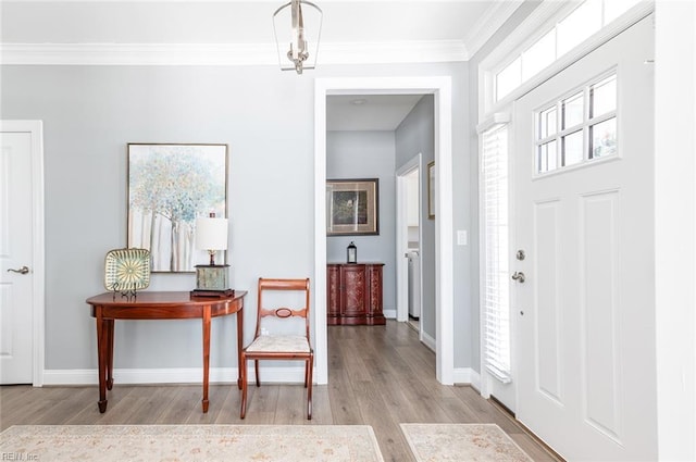 entryway featuring light wood-type flooring, baseboards, and crown molding