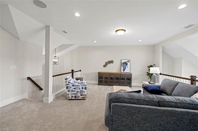 carpeted living room featuring lofted ceiling and a chandelier