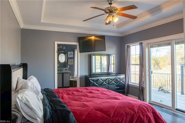 bedroom featuring a tray ceiling, access to outside, crown molding, and ensuite bath