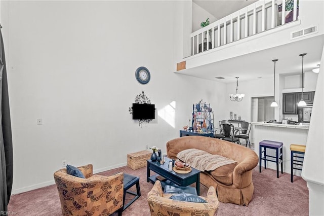 living room featuring carpet flooring, an inviting chandelier, and a towering ceiling