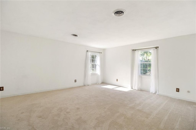 unfurnished room with light carpet and visible vents