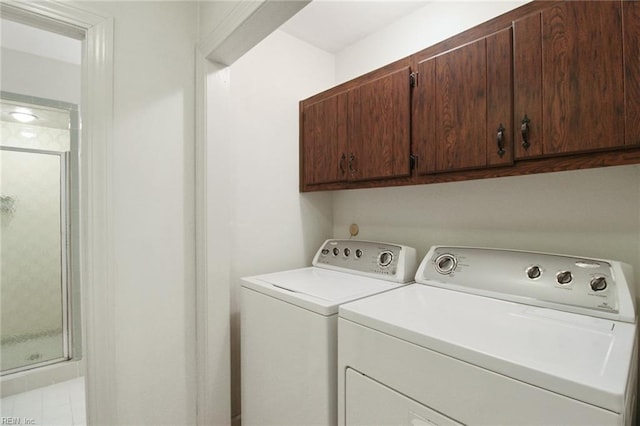 laundry room with cabinet space and separate washer and dryer