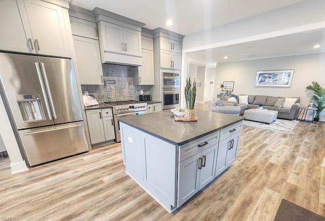 kitchen with light wood-type flooring, stainless steel appliances, and gray cabinetry