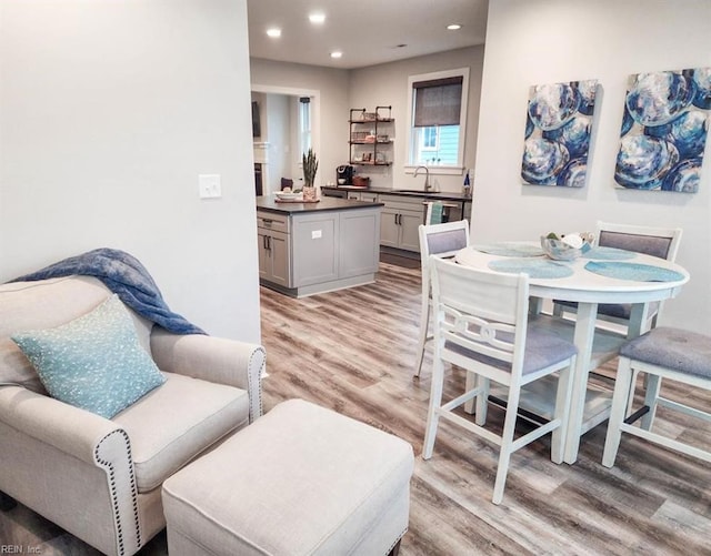 dining space featuring sink and light hardwood / wood-style floors