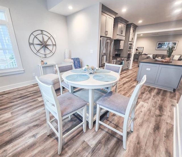 dining area with dark hardwood / wood-style flooring