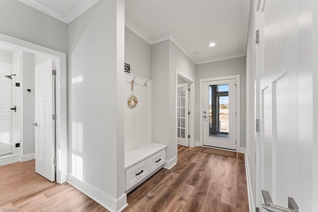 mudroom with crown molding and wood-type flooring