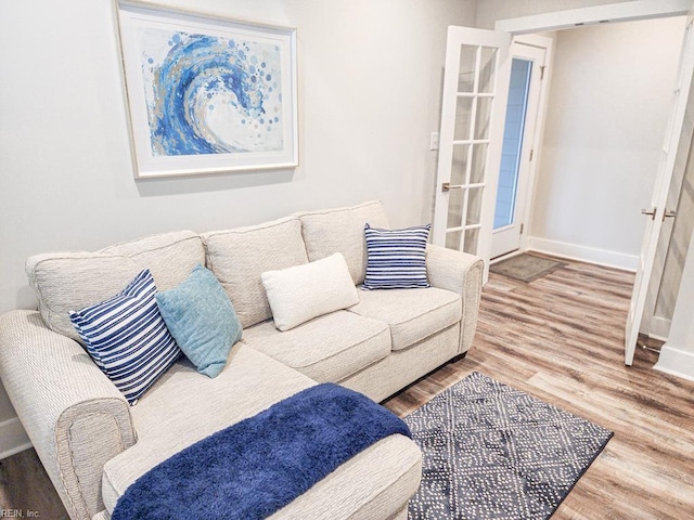 living room with french doors and hardwood / wood-style floors